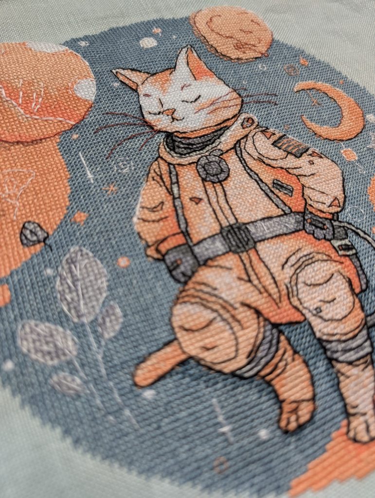 Completed cross stitch of space cat astronaut